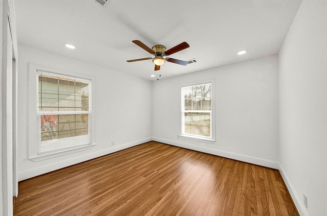 spare room featuring hardwood / wood-style floors and ceiling fan