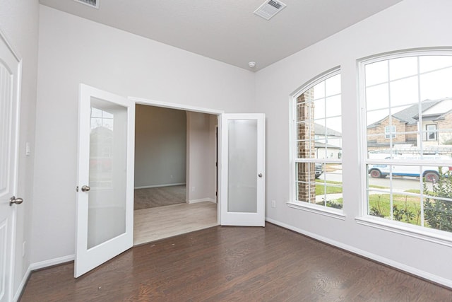 unfurnished room featuring dark wood-type flooring and french doors