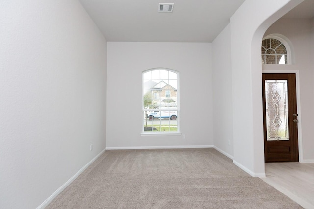 unfurnished room with light carpet