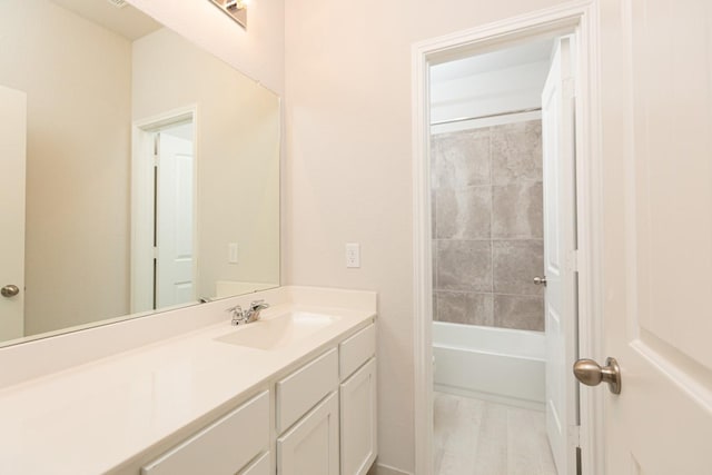 bathroom featuring vanity and tiled shower / bath