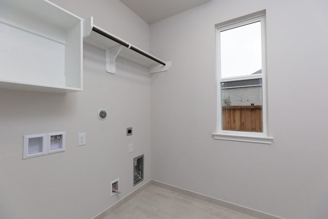 washroom with hookup for a washing machine, gas dryer hookup, electric dryer hookup, and light hardwood / wood-style floors