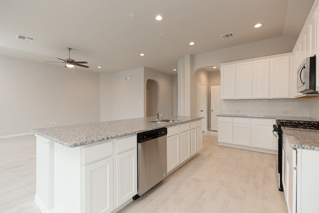 kitchen with a kitchen island with sink, white cabinets, and appliances with stainless steel finishes