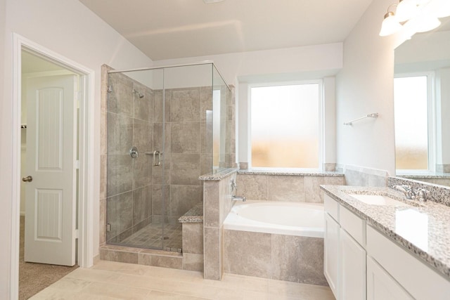 bathroom featuring independent shower and bath, vanity, and tile patterned floors