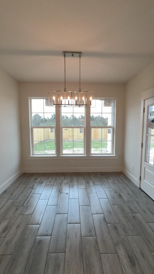 unfurnished dining area with a wealth of natural light and a chandelier