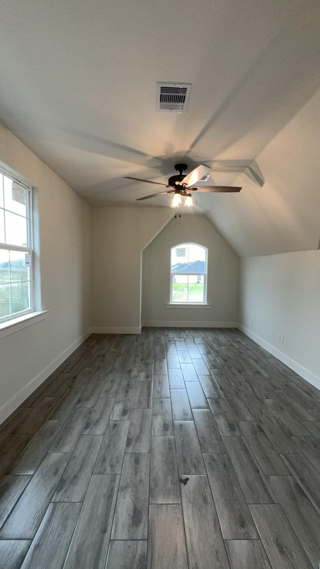 bonus room featuring dark wood-type flooring, ceiling fan, and vaulted ceiling