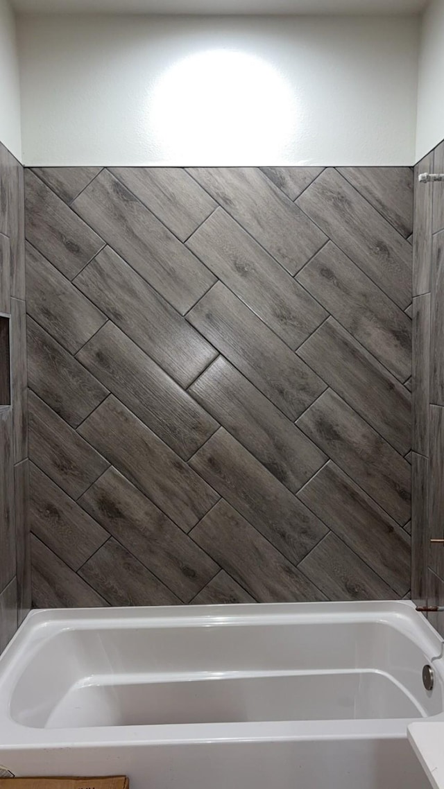 bathroom featuring a tub to relax in and wood-type flooring