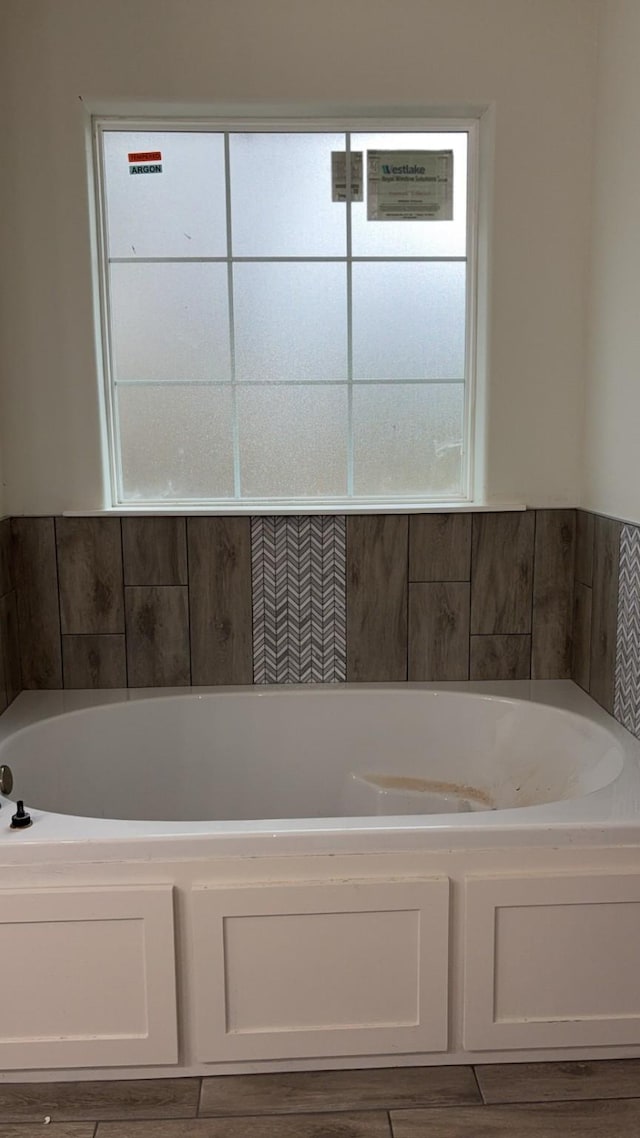 bathroom featuring a tub to relax in