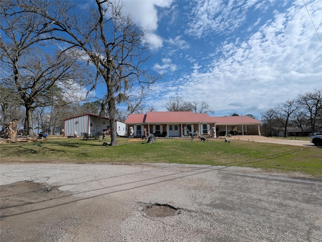 ranch-style home featuring a carport and a front yard