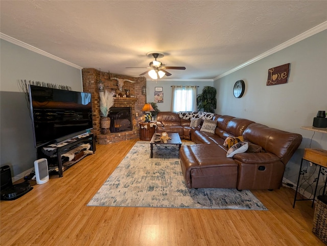 living area featuring ceiling fan, ornamental molding, and wood finished floors