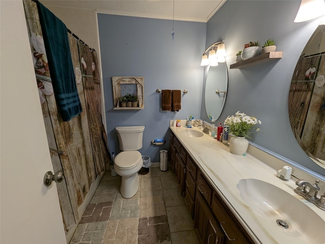 full bath with double vanity, baseboards, toilet, and a sink