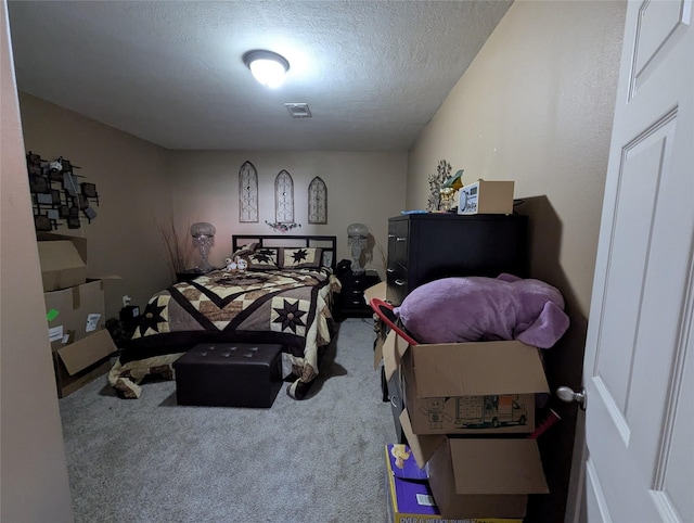 bedroom featuring carpet and a textured ceiling