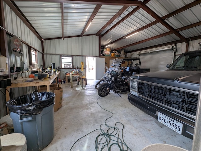 garage featuring a workshop area and metal wall