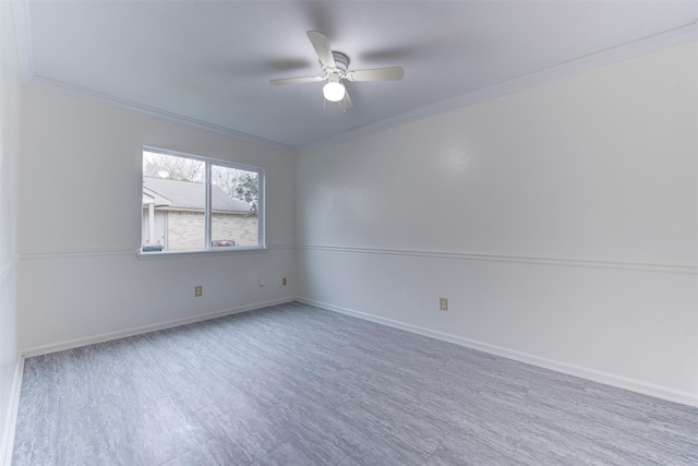 spare room with hardwood / wood-style flooring, crown molding, and ceiling fan