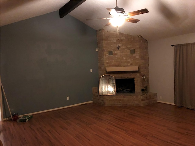 unfurnished living room featuring lofted ceiling with beams, a brick fireplace, wood finished floors, and a ceiling fan