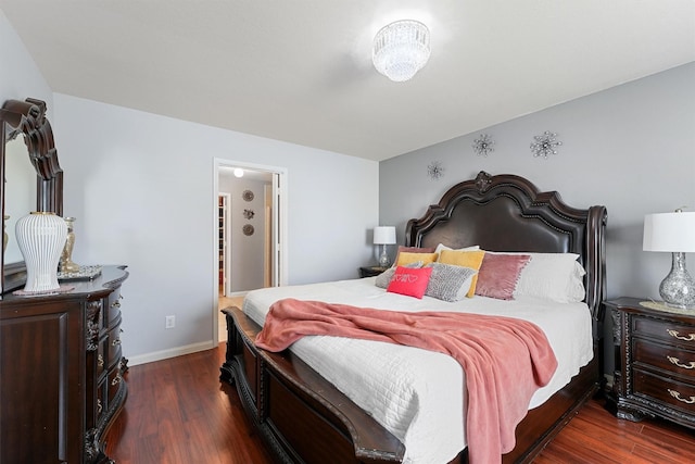 bedroom with dark hardwood / wood-style floors