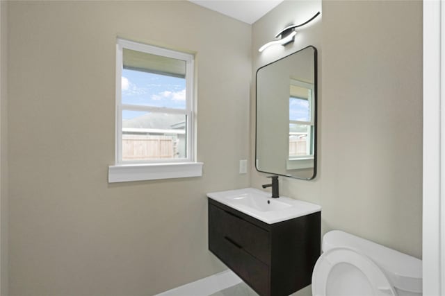 bathroom featuring vanity and toilet