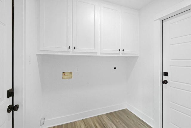 laundry area featuring hookup for an electric dryer, hookup for a washing machine, cabinets, and light wood-type flooring