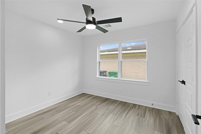 spare room with ceiling fan and light wood-type flooring