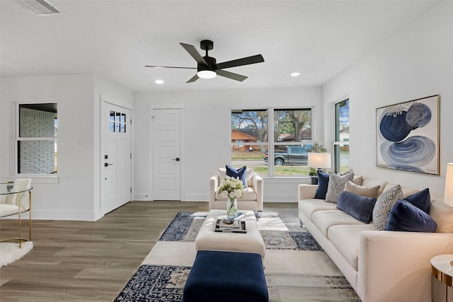 living room with wood-type flooring and ceiling fan