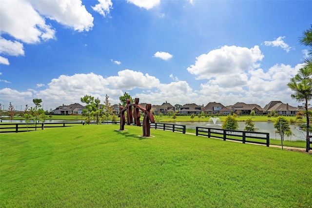 exterior space featuring a yard, playground community, a water view, and a residential view