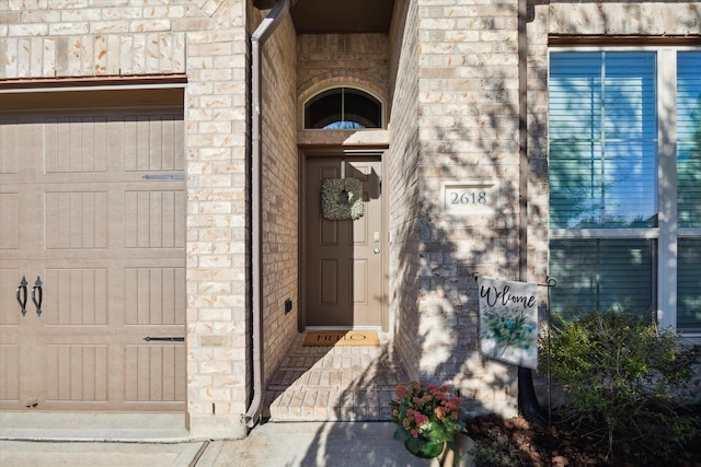 entrance to property featuring stone siding and brick siding