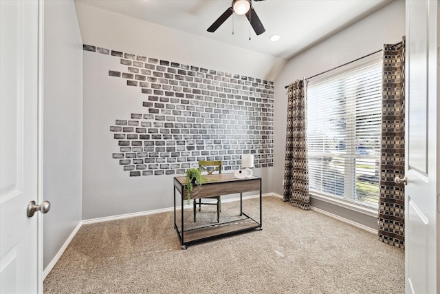 office space with carpet floors, lofted ceiling, ceiling fan, and baseboards