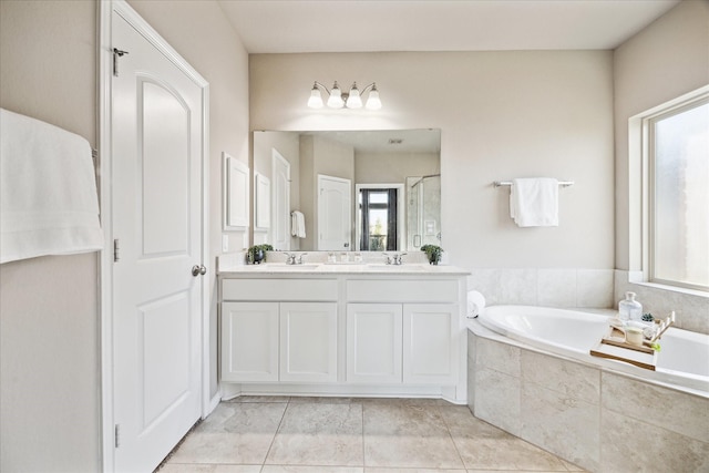 full bath featuring a healthy amount of sunlight, a garden tub, and a shower stall