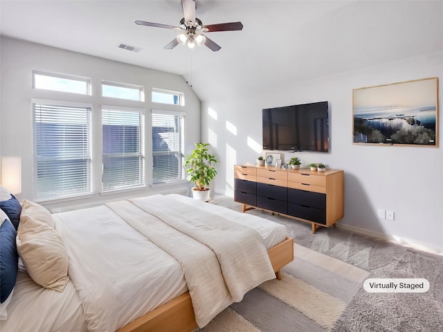 carpeted bedroom featuring lofted ceiling and ceiling fan