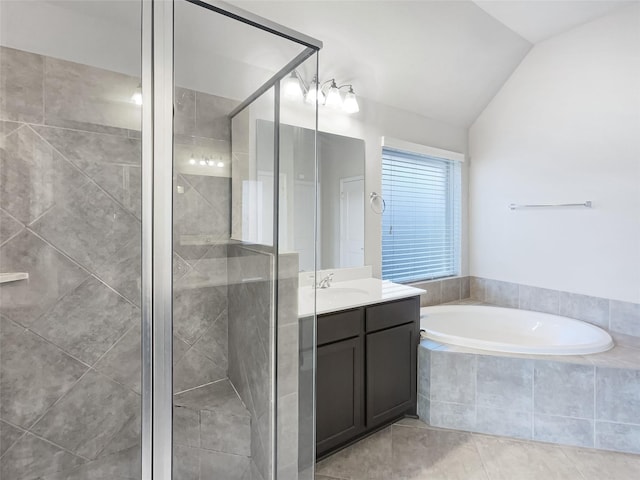 bathroom with tile patterned flooring, vanity, lofted ceiling, and shower with separate bathtub