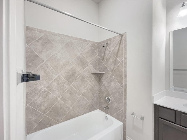 bathroom with tiled shower / bath and vanity