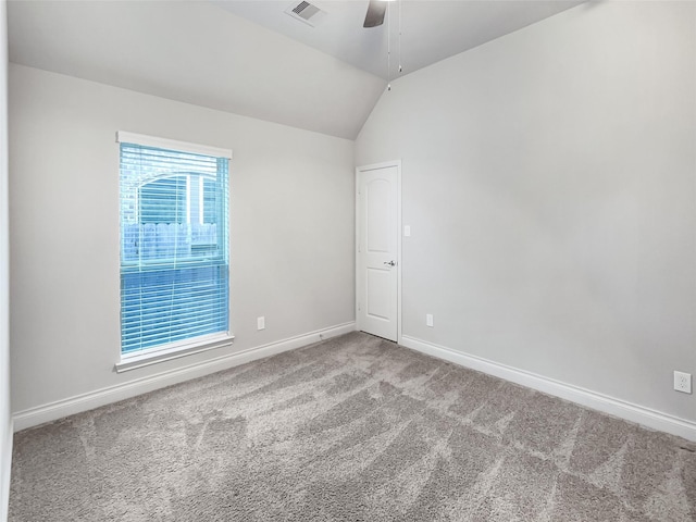 carpeted spare room with lofted ceiling and ceiling fan