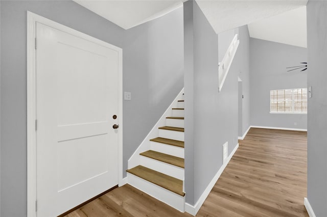 stairs with hardwood / wood-style flooring