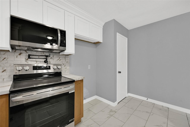 kitchen featuring decorative backsplash, stainless steel appliances, and white cabinets