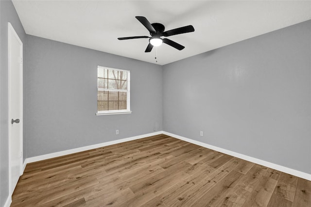 empty room with hardwood / wood-style flooring and ceiling fan