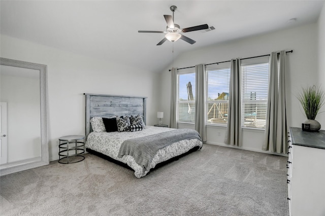 bedroom featuring vaulted ceiling, light carpet, and ceiling fan