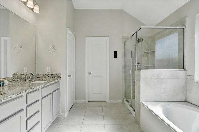 bathroom featuring vanity, vaulted ceiling, tile patterned floors, and plus walk in shower