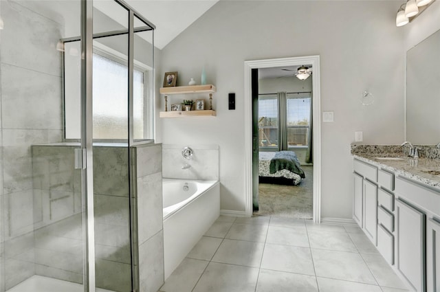 bathroom featuring vaulted ceiling, vanity, independent shower and bath, ceiling fan, and tile patterned flooring