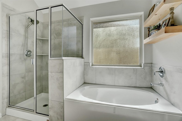 bathroom featuring separate shower and tub and a wealth of natural light