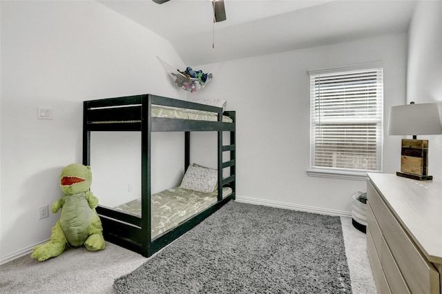 carpeted bedroom featuring ceiling fan and vaulted ceiling