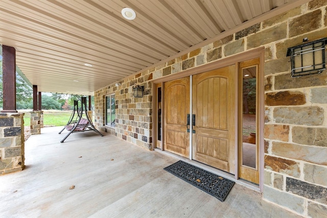 view of exterior entry featuring a porch