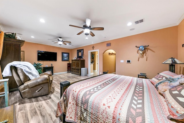 bedroom featuring ornamental molding, ceiling fan, and light hardwood / wood-style flooring