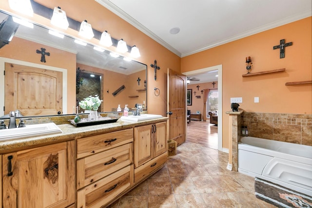 bathroom featuring crown molding, vanity, and a bathtub