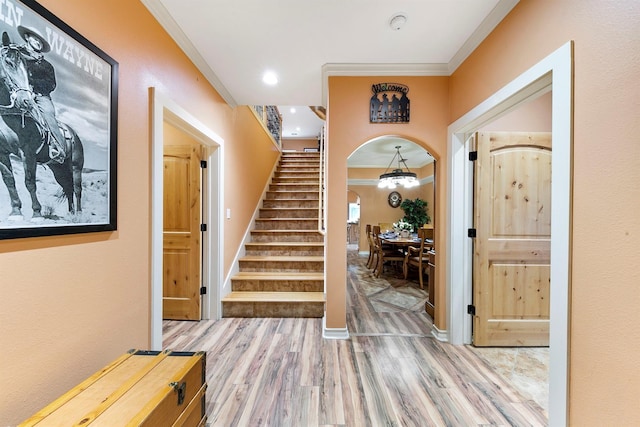 entrance foyer with hardwood / wood-style flooring and crown molding