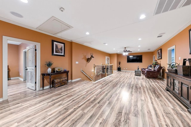 interior space featuring ceiling fan, ornamental molding, and light wood-type flooring