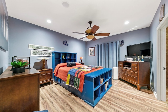 bedroom with ceiling fan and light hardwood / wood-style floors