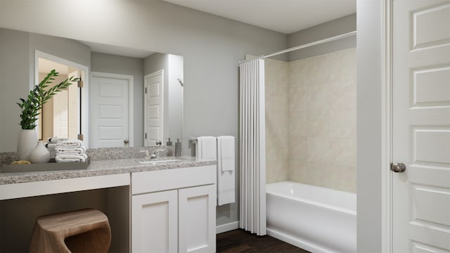 bathroom featuring vanity, hardwood / wood-style floors, and tiled shower / bath combo