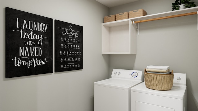 clothes washing area with washing machine and dryer