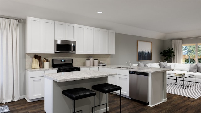 kitchen featuring a kitchen island, appliances with stainless steel finishes, sink, white cabinets, and dark hardwood / wood-style flooring