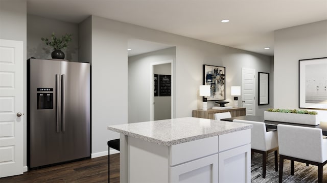 kitchen with white cabinetry, dark hardwood / wood-style floors, a center island, and stainless steel fridge with ice dispenser