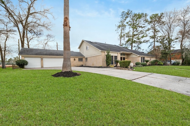 ranch-style home with a garage and a front lawn